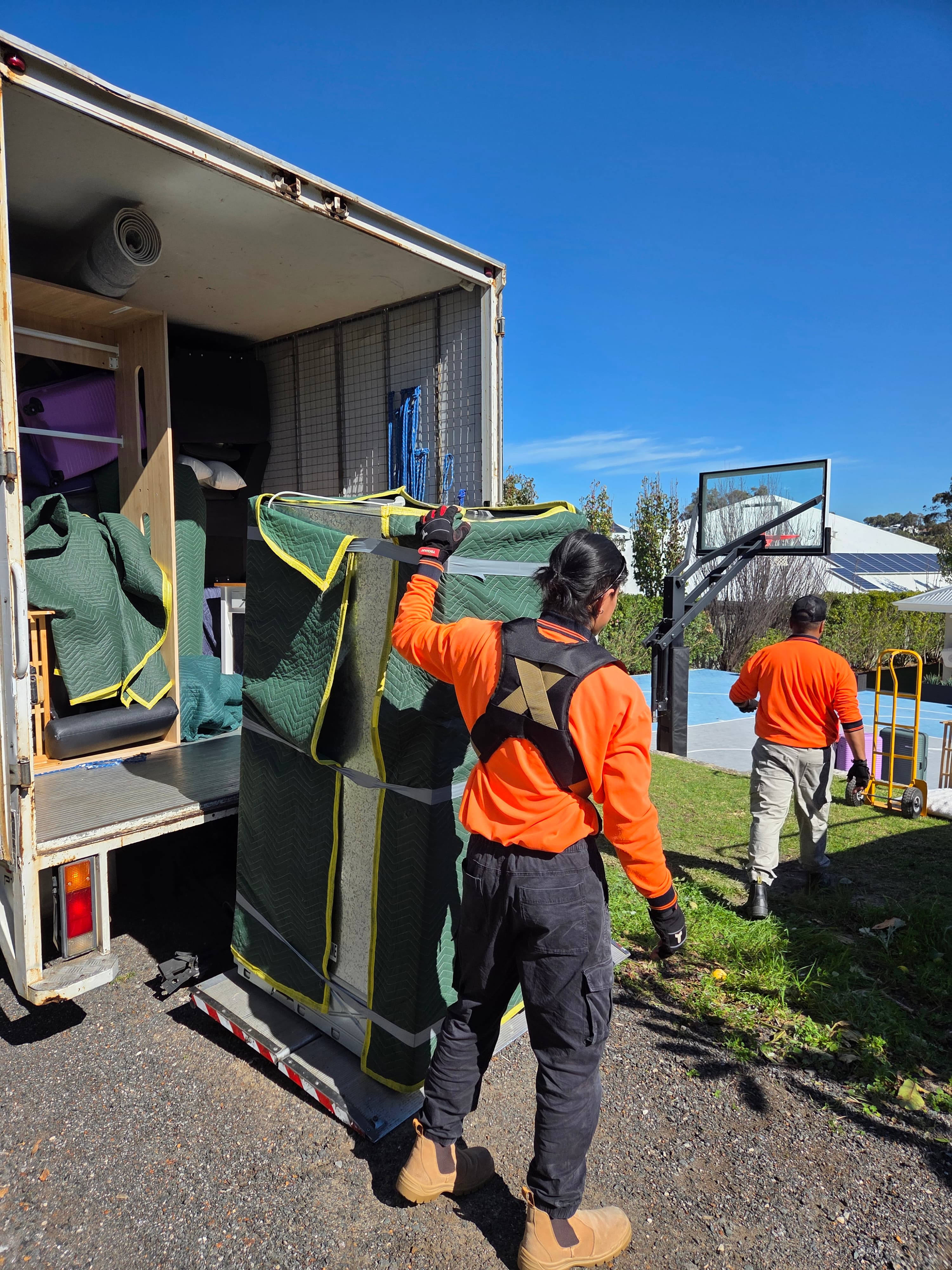 Crew moving a heavy item during a Perth removal